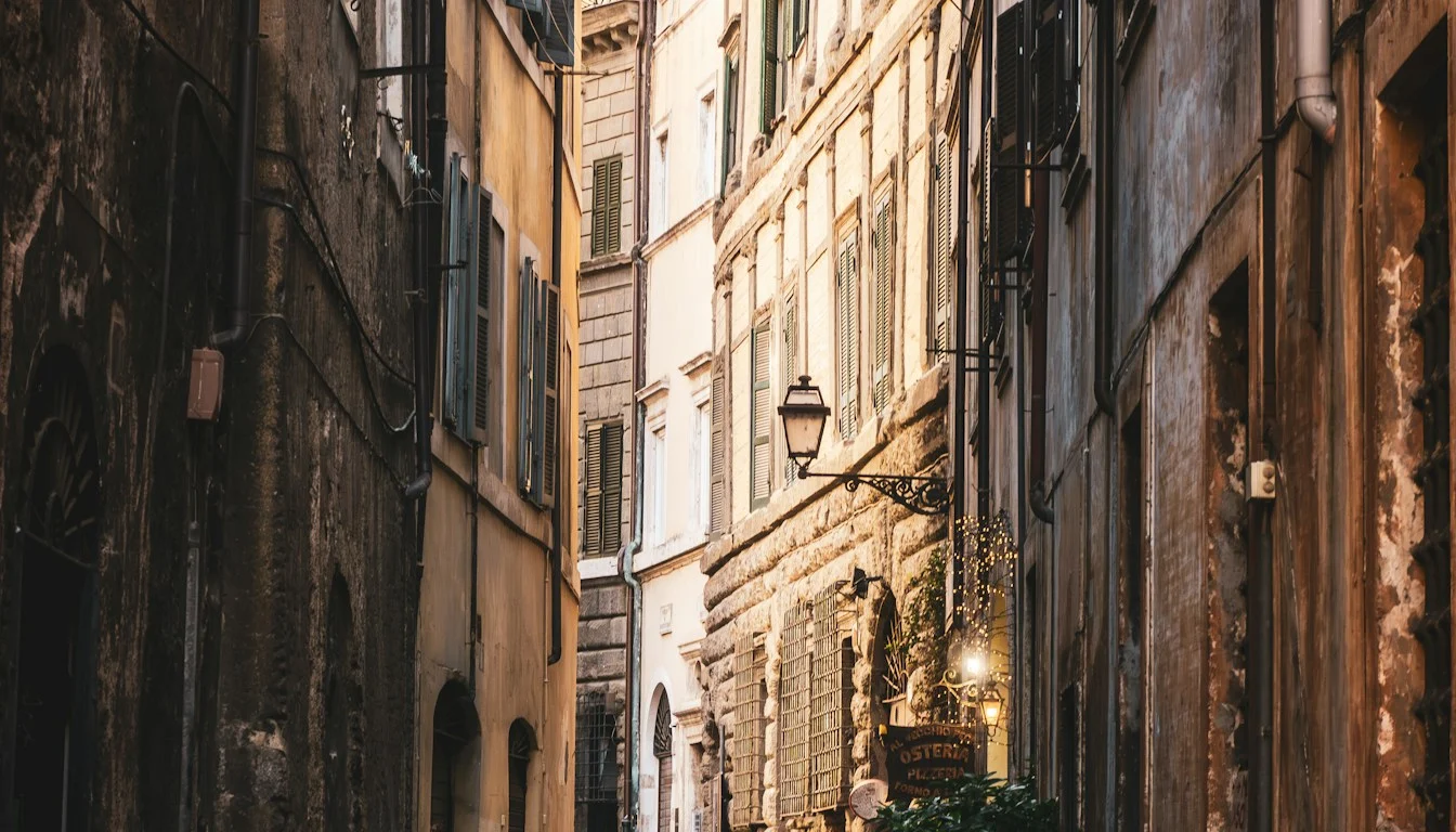 A narrow cobbled alley between tall weathered buildings